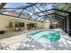 Spacious screened-in pool area with a dining area and outdoor kitchen at 2067 Tocobaga Ln, Nokomis, FL 34275