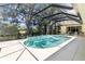Spacious screened-in pool area with bright sunlight and view of the verdant lawn at 2067 Tocobaga Ln, Nokomis, FL 34275
