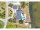 Aerial view of home showcasing backyard pool, patio, landscaping, and waterway access at 2100 Oyster Creek Dr, Englewood, FL 34224