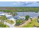 Charming blue home featuring waterfront access and outdoor pool for luxury and relaxation at 2100 Oyster Creek Dr, Englewood, FL 34224