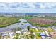 Aerial view overlooking a lake, neighborhood, and green landscape at 2100 Oyster Creek Dr, Englewood, FL 34224