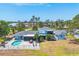 Aerial view of the property highlighting the pool, patio, and well-maintained lawn at 2100 Oyster Creek Dr, Englewood, FL 34224