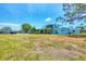 Large grassy backyard includes swimming pool, patio, and canal front views at 2100 Oyster Creek Dr, Englewood, FL 34224
