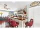 Home bar featuring a long countertop, ample shelving, and seating for entertaining guests at 2100 Oyster Creek Dr, Englewood, FL 34224