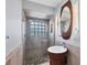 A well-designed bathroom with stylish fixtures, a modern sink, and a glass-enclosed shower at 2100 Oyster Creek Dr, Englewood, FL 34224