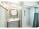 A charming bathroom with a unique mirror and vanity, paired with a convenient stand up shower at 2100 Oyster Creek Dr, Englewood, FL 34224