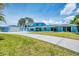 Charming blue home with a spacious yard and long driveway at 2100 Oyster Creek Dr, Englewood, FL 34224