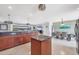 Modern kitchen with dark granite countertops, wood cabinets and an open layout connecting to the dining and living areas at 2100 Oyster Creek Dr, Englewood, FL 34224