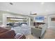 Comfortable living room featuring backyard views through sliding glass doors leading to an outdoor patio at 2100 Oyster Creek Dr, Englewood, FL 34224
