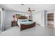 Bright main bedroom featuring a large king bed, two bedside tables, and a closet with shelving at 2100 Oyster Creek Dr, Englewood, FL 34224