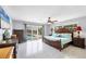 Bright main bedroom with en suite access and featuring a large king bed overlooking the pool at 2100 Oyster Creek Dr, Englewood, FL 34224