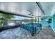 Enclosed patio with comfortable seating and dining area, providing a serene outdoor living space at 2100 Oyster Creek Dr, Englewood, FL 34224