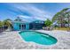 Backyard pool with patio, lush landscaping, and outdoor seating for relaxation and entertainment at 2100 Oyster Creek Dr, Englewood, FL 34224