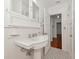 Bright bathroom with a pedestal sink, stylish mirror, and tiled floor near other rooms at 2620 8Th N Ave, St Petersburg, FL 33713