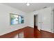 Bright bedroom featuring hardwood floors, white trim, closet, and a sunlit window at 2620 8Th N Ave, St Petersburg, FL 33713