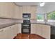 Updated kitchen featuring granite counters, tiled backsplash, and sleek black appliances at 2620 8Th N Ave, St Petersburg, FL 33713