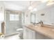 Bright bathroom featuring a glass-enclosed shower and a vanity at 2726 Silver King Way, Sarasota, FL 34231