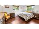 Comfortable bedroom with hardwood floors, a large window, and comfortable furnishings at 2726 Silver King Way, Sarasota, FL 34231