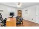 This bedroom has hardwood floors, a ceiling fan, and a workspace with a desk and office chair at 2726 Silver King Way, Sarasota, FL 34231