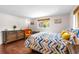 Cozy bedroom with hardwood floors, a large window, and comfortable furnishings at 2726 Silver King Way, Sarasota, FL 34231