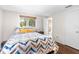 Bright bedroom with hardwood floors, a large window, and an ensuite bathroom at 2726 Silver King Way, Sarasota, FL 34231