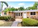 Inviting ranch-style home with mature landscaping, a brick walkway, and a covered front porch at 2726 Silver King Way, Sarasota, FL 34231