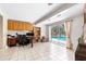 Bright home office with built-in shelves, a desk, and a sliding glass door to the pool area at 2726 Silver King Way, Sarasota, FL 34231