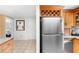 Galley kitchen featuring stainless steel refrigerator and upper wine rack storage at 2726 Silver King Way, Sarasota, FL 34231