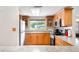 Well-lit kitchen featuring wood cabinets, stainless appliances and a window over the sink at 2726 Silver King Way, Sarasota, FL 34231