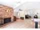 Open living room with a brick fireplace, tile flooring, and a view of the entryway at 2726 Silver King Way, Sarasota, FL 34231