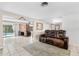 Spacious living room boasts tile floors, neutral walls, a fireplace, and backyard pool access at 2726 Silver King Way, Sarasota, FL 34231