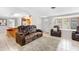 Open-concept living room with tile flooring, abundant natural light, and comfortable seating at 2726 Silver King Way, Sarasota, FL 34231