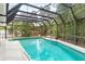 This screened pool is surrounded by tropical foliage at 2726 Silver King Way, Sarasota, FL 34231
