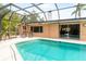This screened pool has lounge chairs and poolside dining at 2726 Silver King Way, Sarasota, FL 34231