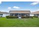 Screened-in porch surrounded by manicured hedges and greenery at 2733 Riverbluff Pl # V57, Sarasota, FL 34231