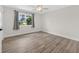 Bright bedroom with wood-look flooring, a large window, and neutral wall color at 2733 Riverbluff Pl # V57, Sarasota, FL 34231