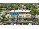 Aerial view of the community pool and clubhouse with views of the docks and boating waterway at 2733 Riverbluff Pl # V57, Sarasota, FL 34231