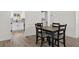 The dining area features wood-look tile flooring and a table with four chairs adjacent to the kitchen at 2733 Riverbluff Pl # V57, Sarasota, FL 34231