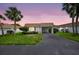 Charming villa featuring a covered carport, lush landscaping, and a well-maintained lawn at 2733 Riverbluff Pl # V57, Sarasota, FL 34231