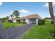 Charming single-story home with a carport, a well-manicured lawn, and mature palm trees at 2733 Riverbluff Pl # V57, Sarasota, FL 34231