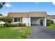 Charming villa with a covered carport and lush front yard landscaping at 2733 Riverbluff Pl # V57, Sarasota, FL 34231