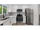 Updated kitchen with stainless steel appliances and white cabinets providing a clean and modern space at 2733 Riverbluff Pl # V57, Sarasota, FL 34231