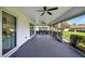 Spacious screened-in lanai with a ceiling fan and views of the landscaped backyard at 2733 Riverbluff Pl # V57, Sarasota, FL 34231