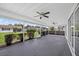 Large screened lanai with ceiling fans overlooking a beautifully landscaped yard and neighboring properties at 2733 Riverbluff Pl # V57, Sarasota, FL 34231