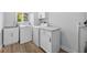 Laundry room featuring a washer, dryer, utility sink, and built in cabinets at 2733 Riverbluff Pl # V57, Sarasota, FL 34231