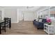 Bright living room with wood-look flooring, large windows with plantation shutters, and a ceiling fan at 2733 Riverbluff Pl # V57, Sarasota, FL 34231
