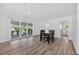 Spacious living room with access to the kitchen, dining area, and a glass sliding door to the lanai at 2733 Riverbluff Pl # V57, Sarasota, FL 34231