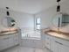 Relaxing bathroom featuring soaking tub, double vanities, and stylish fixtures at 2881 Pope St, North Port, FL 34287
