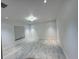 Bright bedroom featuring neutral walls, recessed lighting, and modern chandelier at 2881 Pope St, North Port, FL 34287