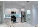 Modern kitchen featuring granite countertops, stainless steel appliances, and stylish backsplash at 2881 Pope St, North Port, FL 34287